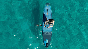 person standing on sup board